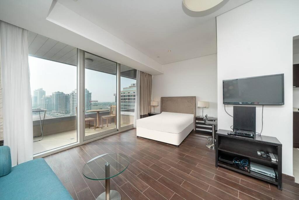Dubai Sports City Apartment | StoneTree - Spacious Studio - The Matrix