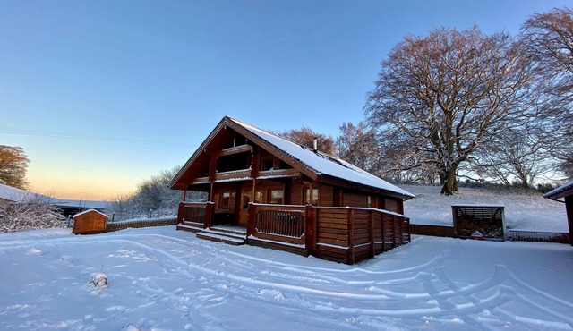 A traditional Scandinavian style lodge, with stylish wooden interior decorated with a Scottish theme in Gorebridge