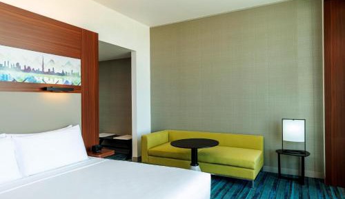 Savvy Suite – King Bed (Living Room + Two Bathrooms + Complimentary Shuttle to Expo Metro Station & Al Maktoum International Airport)